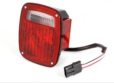 Omix-ADA Right Side Black HousingTail Light Assembly for 91-97 Jeep Wrangler picture