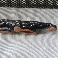 Glossy Clay Black Panther Figurine with Red Mouth and Yellow Eyes picture