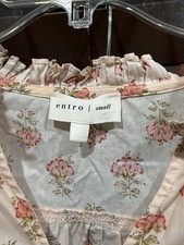 This garment is a pink floral-print small top by Entro/ ruffled collar. picture