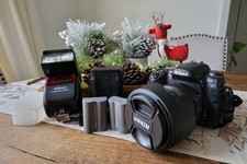 Nikon D 300 with extras( speedlight, 2 batteries, lensehood, carrying case + picture