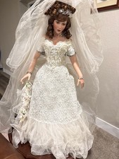 This is a large high-end Victorian bride porcelain collector doll. She features  picture